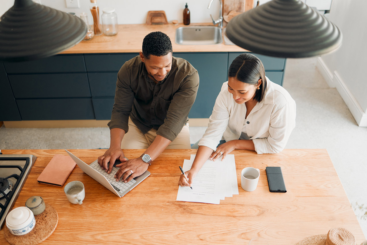 Couple calculating budget, finance and tax while planning investment, loan and bills at home from above