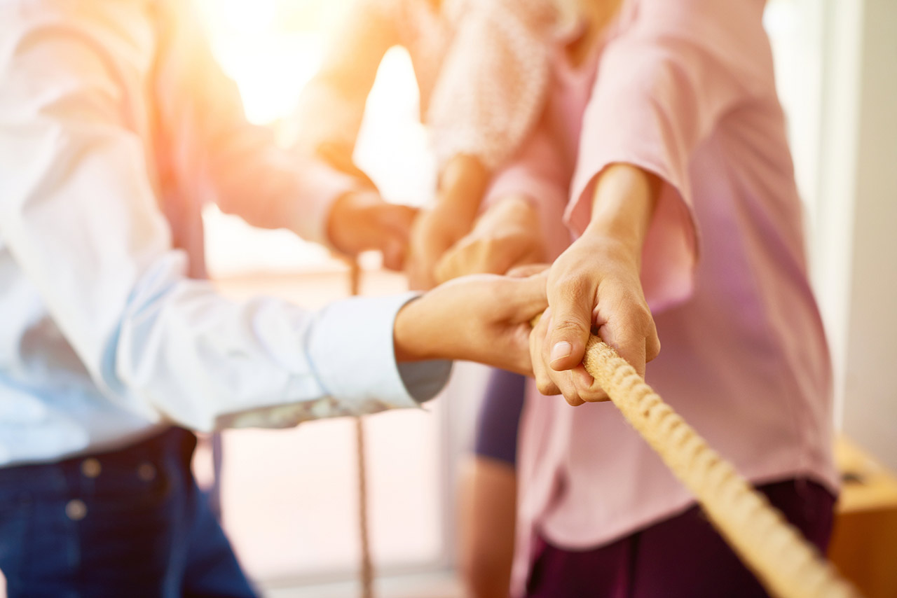 Team of coworker pulling rope together stock photo